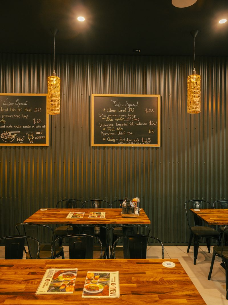 Bà Năm's rattan-lamp dining room on Grote Street — the mood our team brings to your venue
