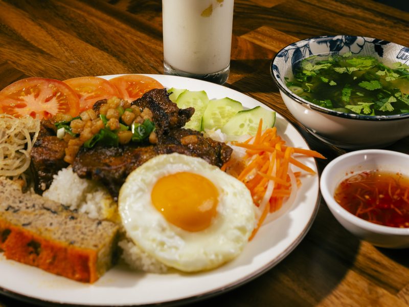Cơm tấm plate with grilled pork, egg and pickled vegetables — the style of our shareable platters